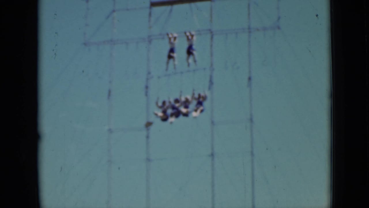 Distant acrobats on high aerial rigging with a grouped act below.