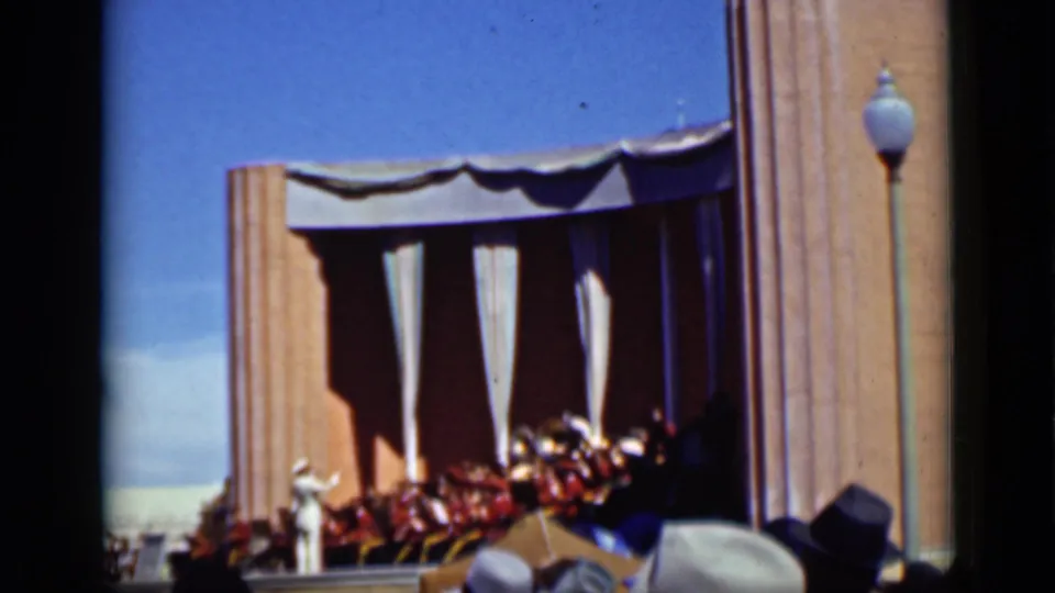 1937 San Francisco home-movie view of an outdoor bandshell with a seated band and spectators watching from below.