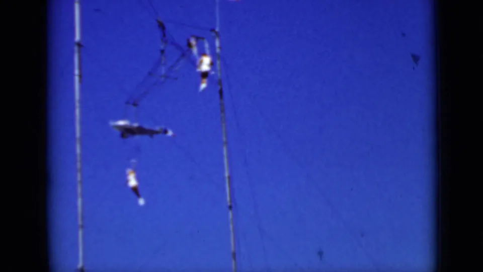 Outdoor 1937 San Francisco trapeze footage shows performers separated across high lines and bars against the sky.