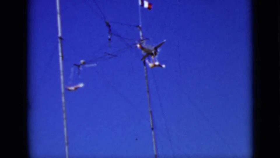 A 1937 San Francisco 8mm frame shows the suspended airplane mobile and small dangling forms shifting in the wind.