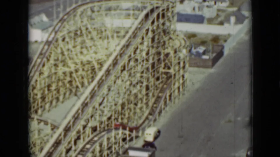 Elevated 1937 San Francisco view of a large wooden roller coaster, showing its lattice structure, curved track, and nearby park grounds.