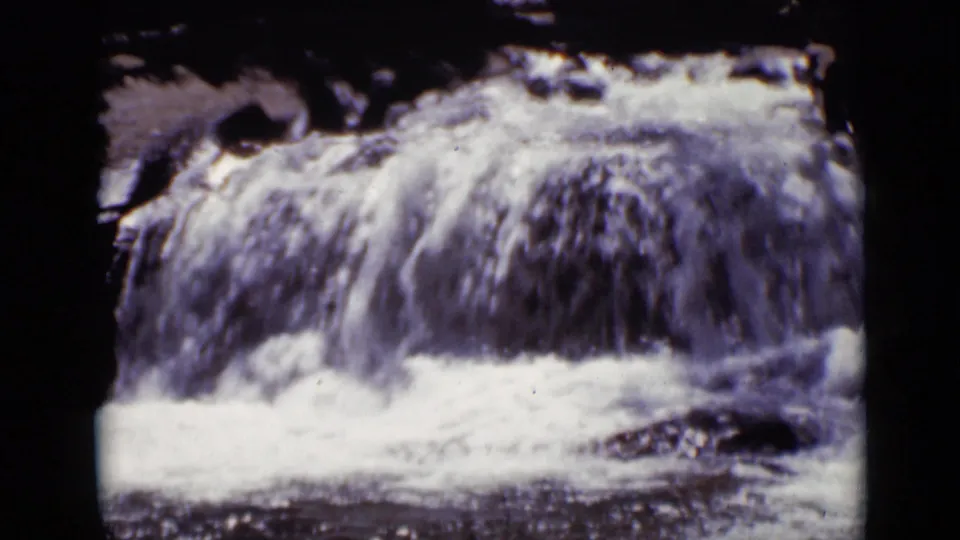 1938 Colorado 8mm frame showing white water rushing over rocks at Copeland Falls.