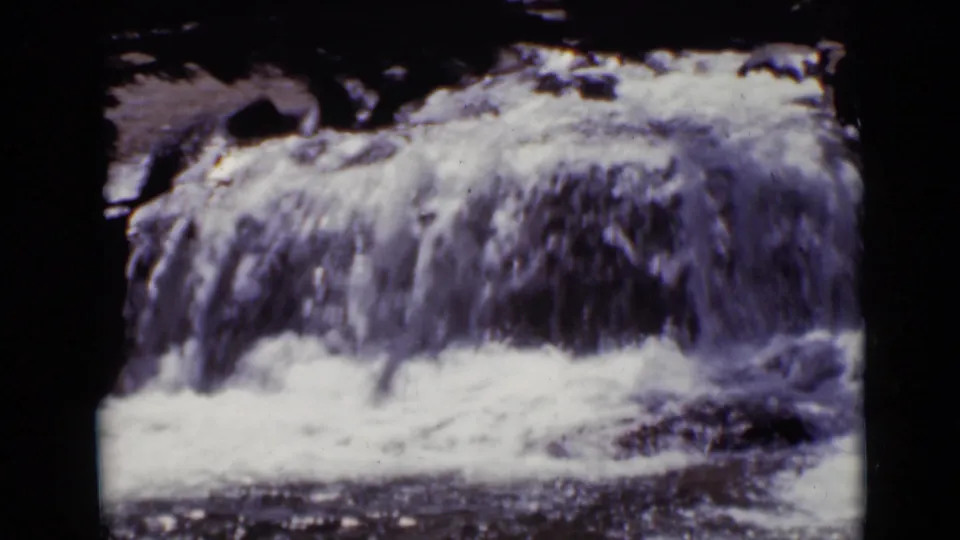1938 Colorado 8mm frame showing the foamy flow of Copeland Falls over dark rock ledges.