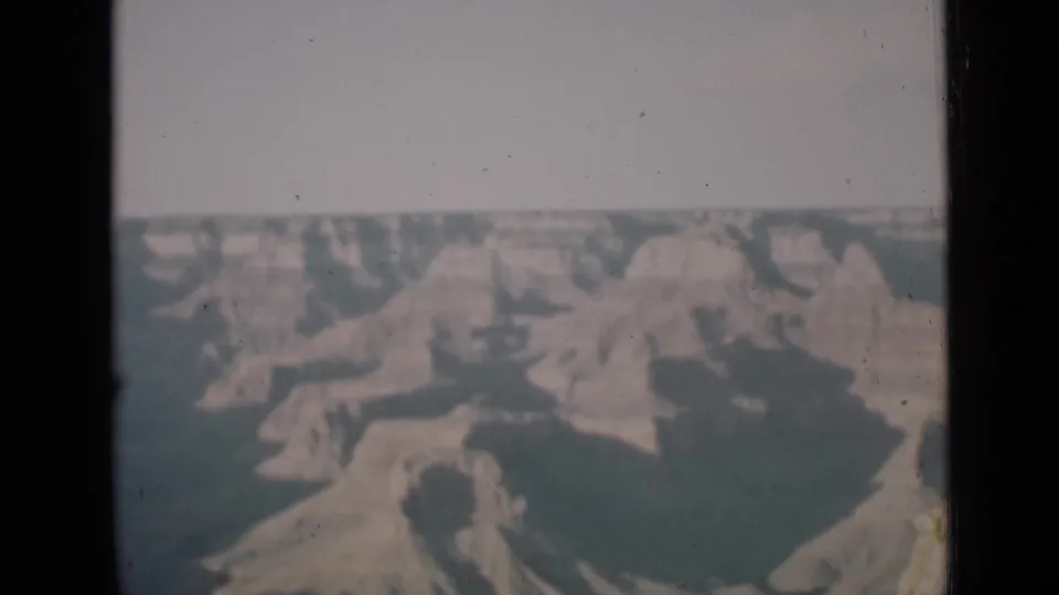 A second Arizona canyon view shows layered rock forms and shadowed gullies in faded 8mm color.