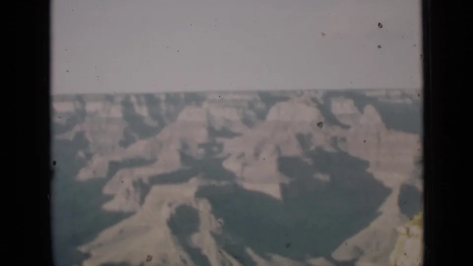 The clip continues with a faded Arizona canyon landscape, showing rock shapes and haze in a home-movie frame.