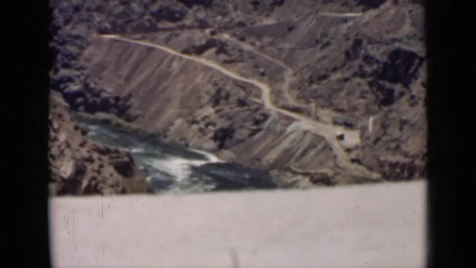 The landscape view continues over an Arizona canyon, with a river, winding road, and rugged slopes filling the frame.