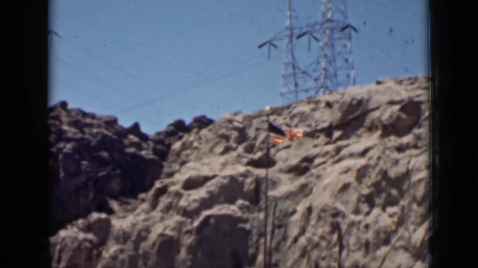 The final frame holds on the flagpole, rocky cliff, and distant transmission towers in 1939 Arizona home-movie footage.