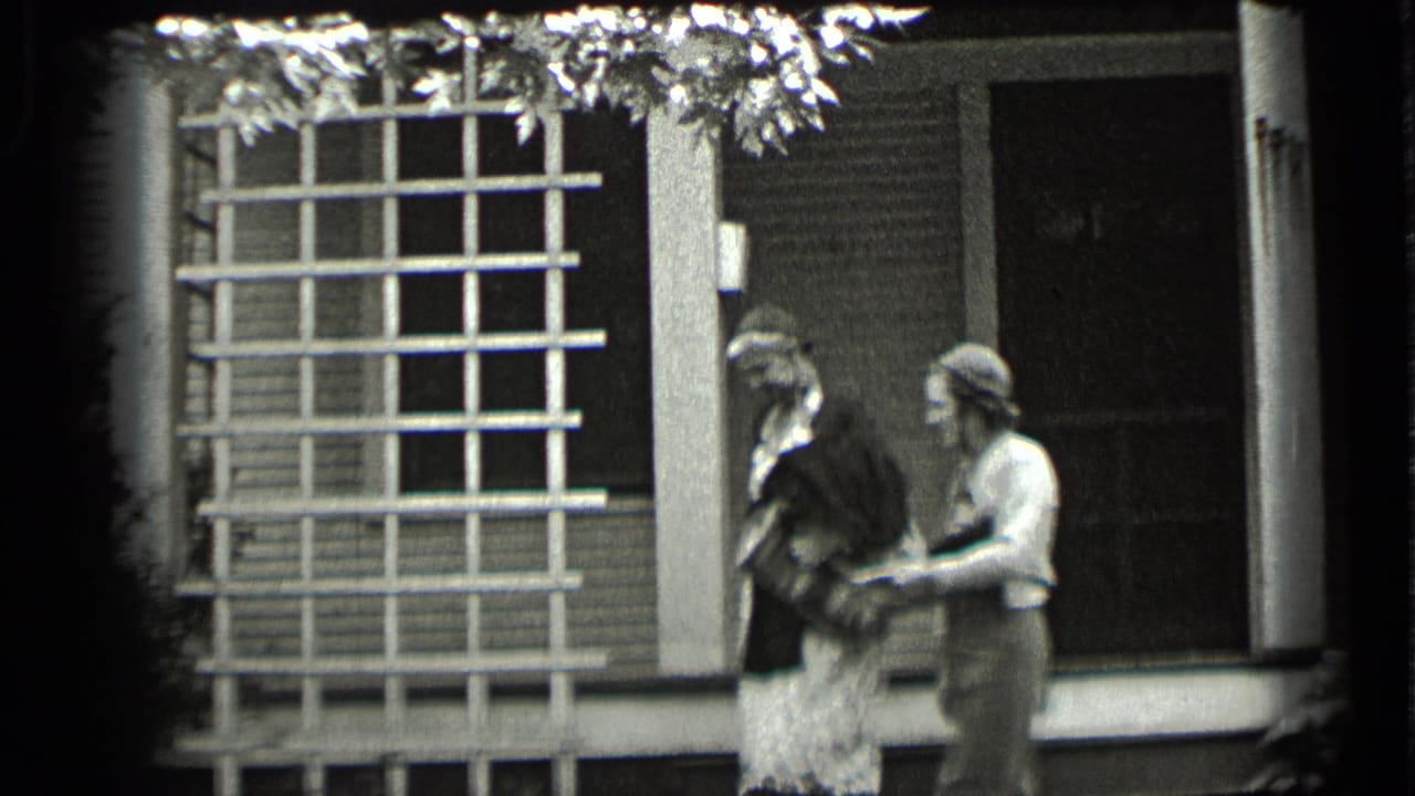 Two women face each other on a porch beside a gridded window.
