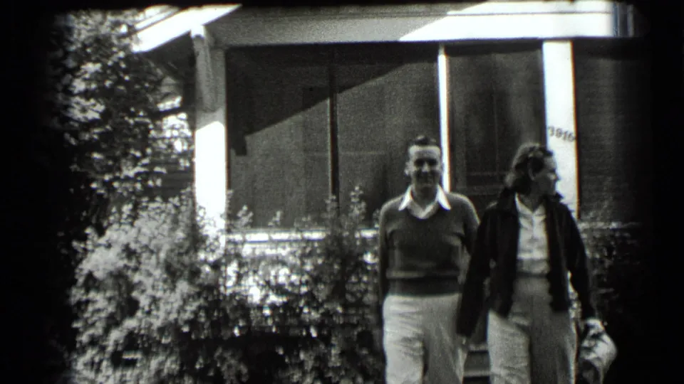 A couple walks outside a house in Clear Lake, California, in supplied 1939 home-movie footage.