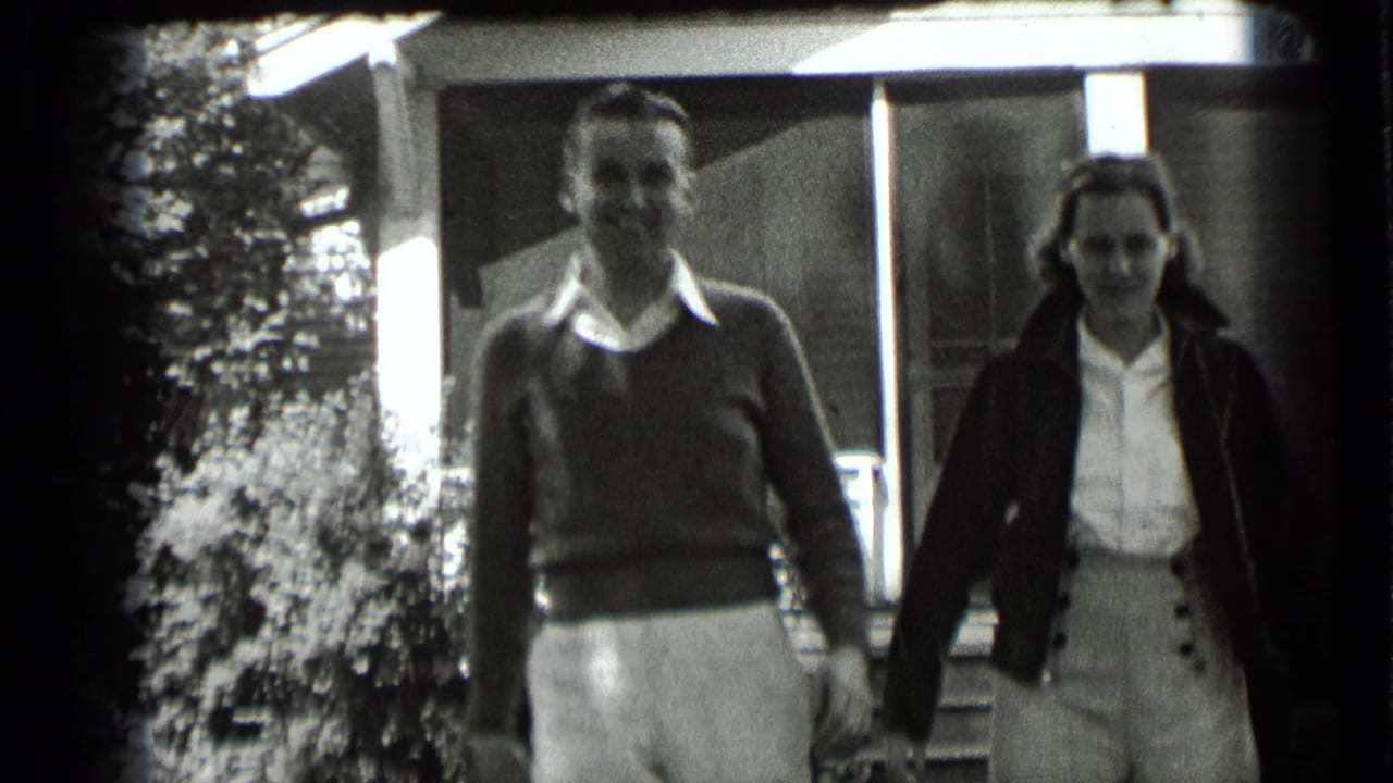 Couple closer to the camera, walking from a house entrance.