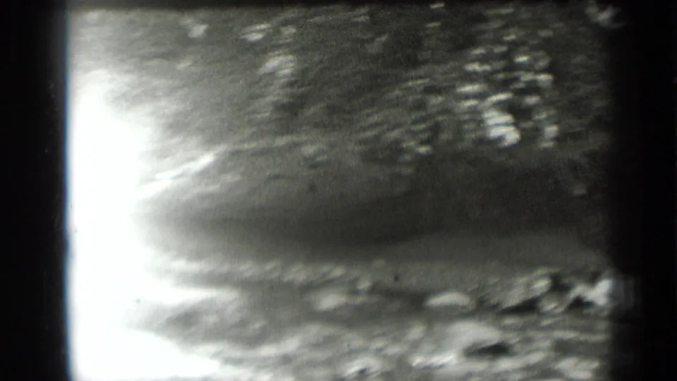 Bright, overexposed view of water, rocks, and shoreline texture in the 1939 Clear Lake footage.