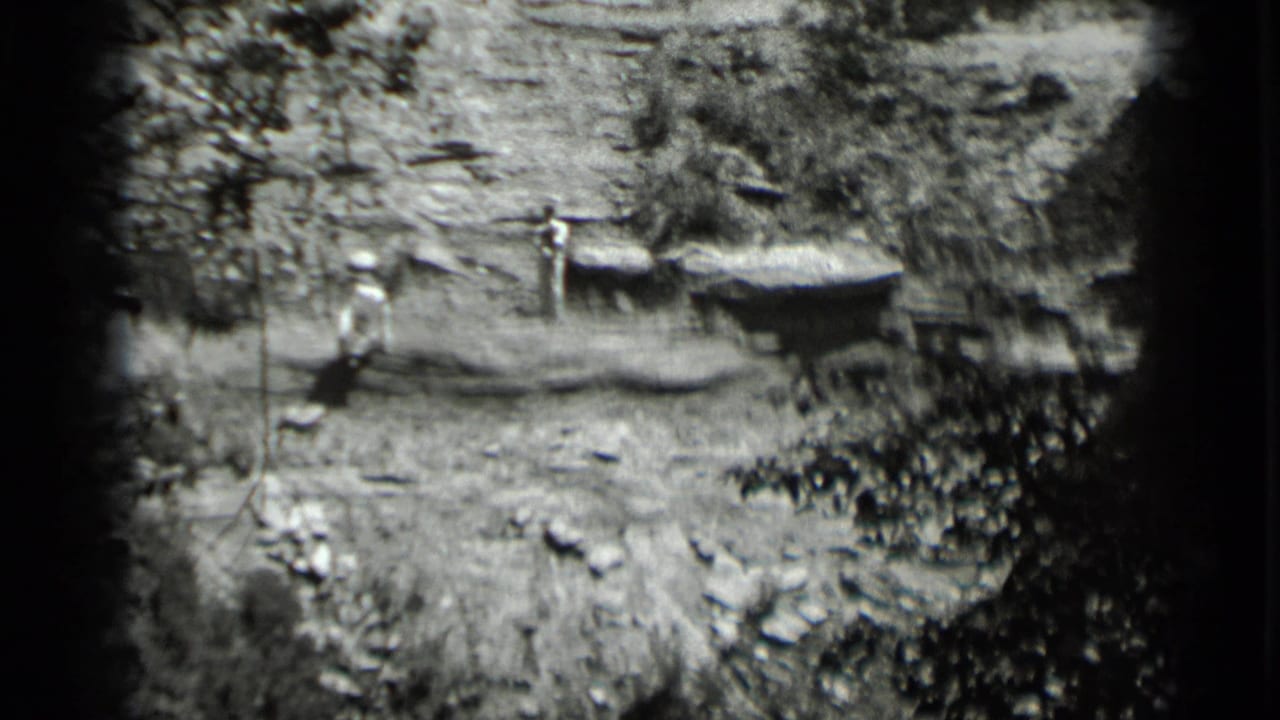 Two men remain near the platforms, with one closer to the left side of the shoreline.