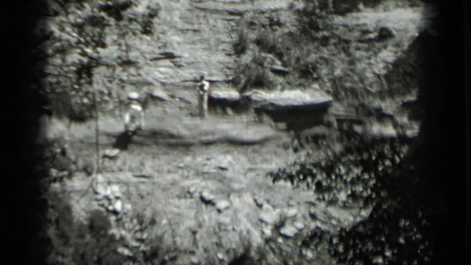 A distant 1939 Clear Lake frame shows two men positioned around separate wooden platforms in a rough lakeside setting.