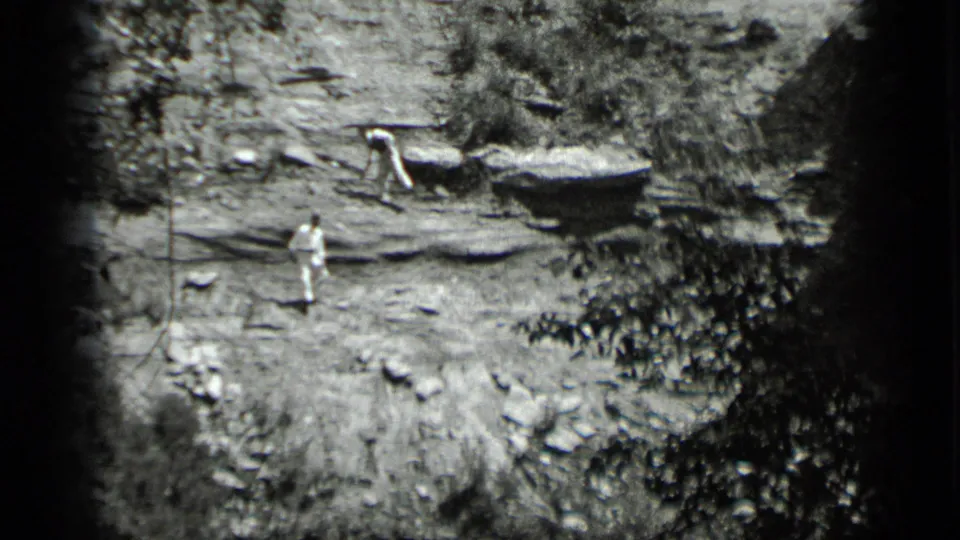 At Clear Lake in 1939, one man stands below as another bends near a higher wooden platform in grainy 8mm footage.