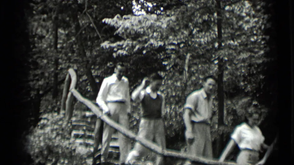 A small group continues down rustic wooded steps in Clear Lake, California, with faces visible in the 1939 footage.
