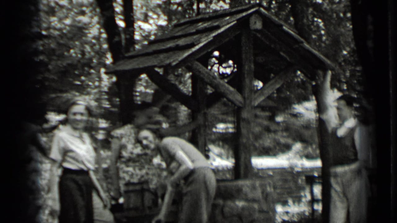 At the end of the Clear Lake clip, two young adults stand by the well as another bends near the bucket area.