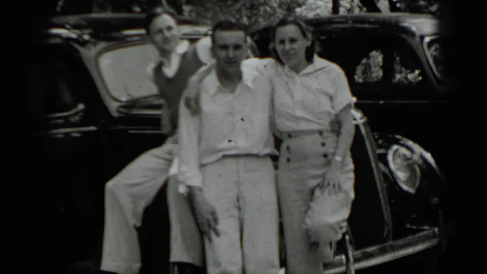 Three young adults pose beside a dark 1930s car in the 1939 Clear Lake home-movie footage.
