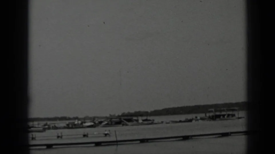 End of the 1939 Clear Lake scan showing docked boats, low shoreline structures, and hills across the bay.