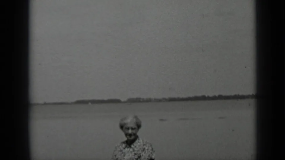 1939 home-movie still of an older woman in a patterned dress facing the camera at Clear Lake, California.