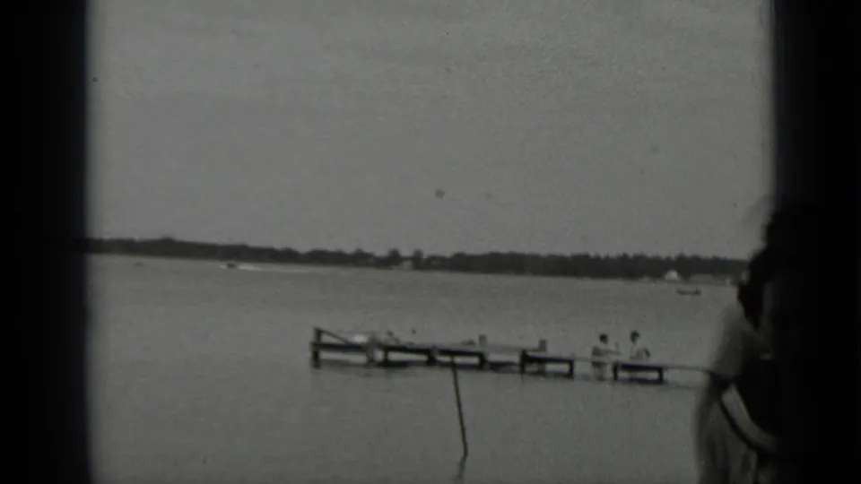A Clear Lake pier extends across the frame in 1939 home-movie footage, with seated people visible near the water.