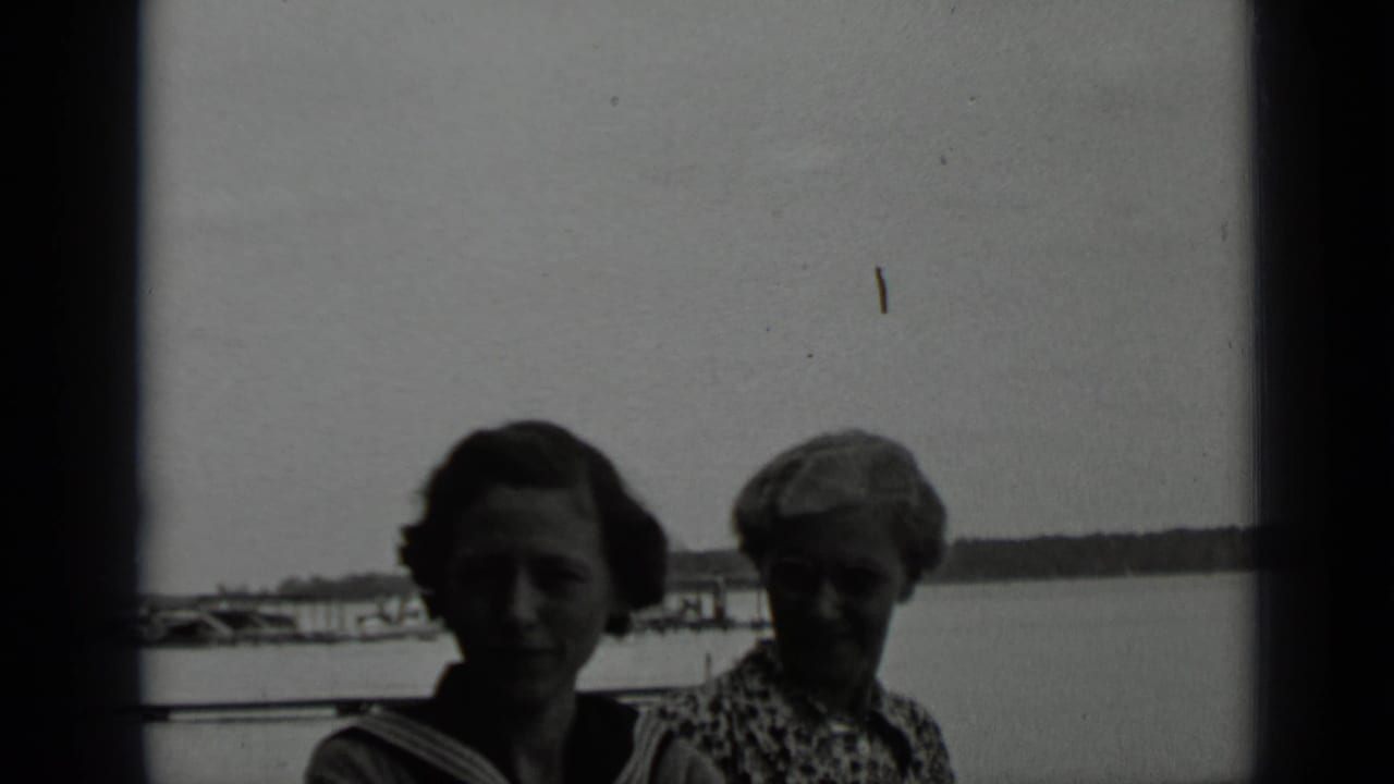 Two women near the water at Clear Lake appear in a high-contrast black-and-white 8mm frame from 1939.