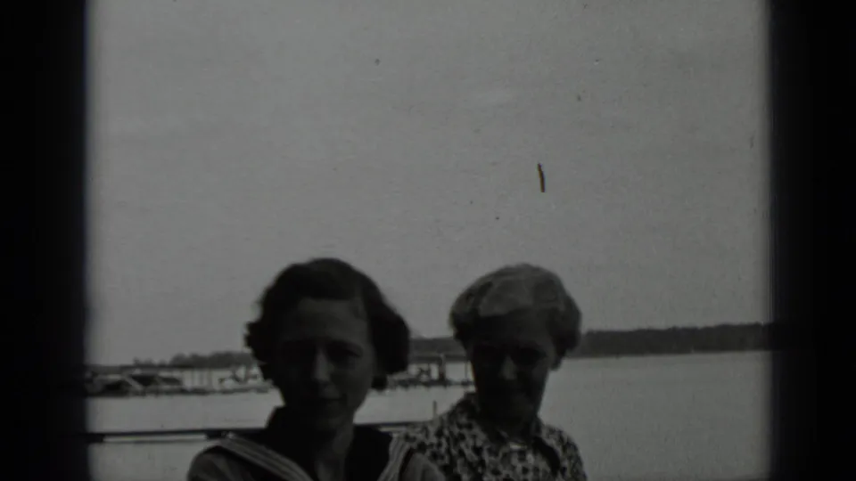 Two women near the water at Clear Lake appear in a high-contrast black-and-white 8mm frame from 1939.