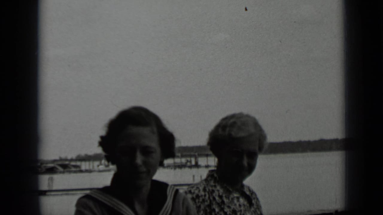 The two women remain framed against Clear Lake, their faces darkened by backlighting in the 1939 home-movie shot.