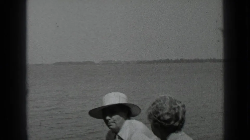 A closer 1939 Clear Lake frame shows the man in a light hat facing the camera while the woman is turned away by the water.