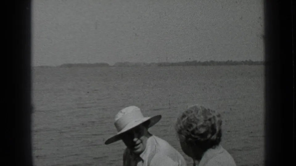 At Clear Lake in 1939, an adult in a white hat turns toward the camera while a companion sits nearby on the boat.