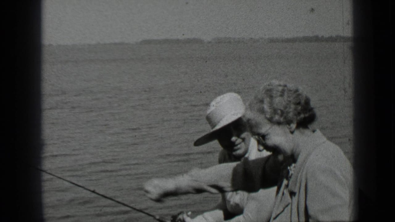 During the 1939 Clear Lake outing, the woman smiles and gestures forward while the man sits nearby with fishing gear visible.