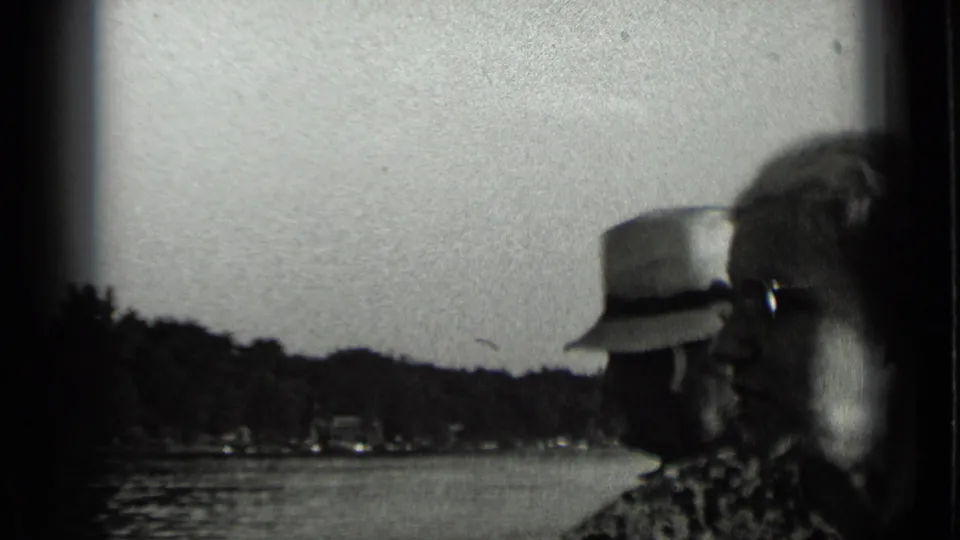 At Clear Lake in 1939, the couple appears in profile beside the water, with wooded hills and distant structures across the lake.