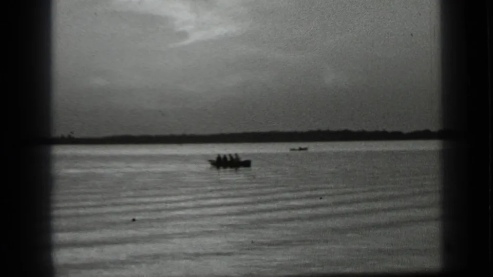 Final frame shows distant boaters on Clear Lake, California, framed by 8mm borders and a low horizon.