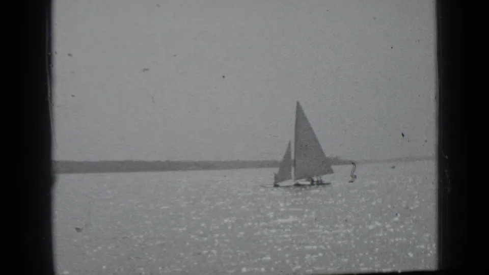1939 Clear Lake, California frame showing the sailboat near center-right on reflective water with visible film wear.