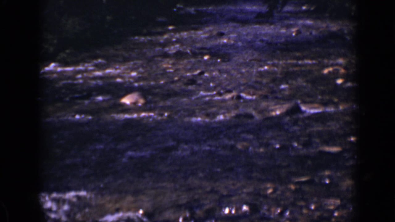 Dark flowing water seen through heavy 8mm frame edges.