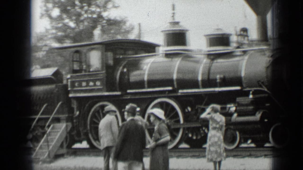 1939 New York frame with townsfolk observing and photographing the displayed steam locomotive from the platform.