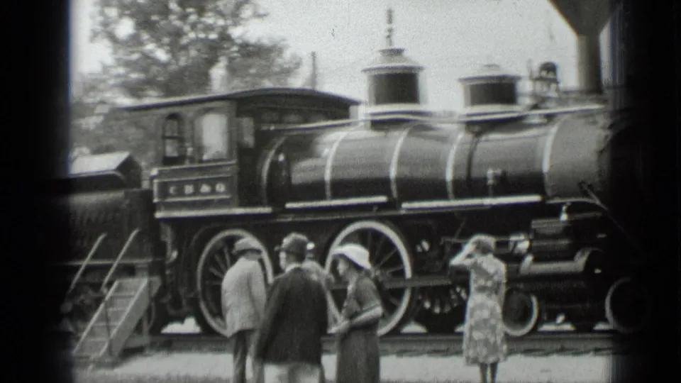 1939 New York frame with townsfolk observing and photographing the displayed steam locomotive from the platform.