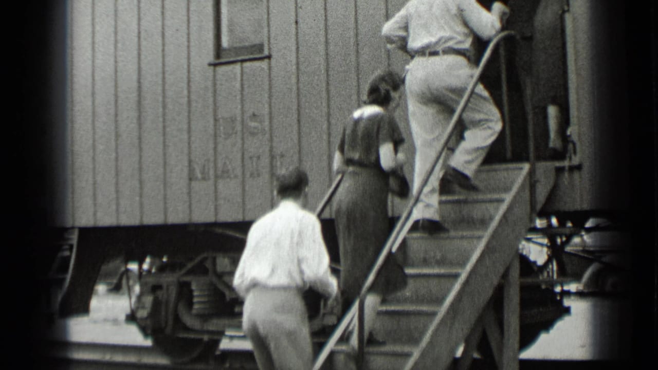 Passengers climb metal stairs into a U.S. Mail train car.
