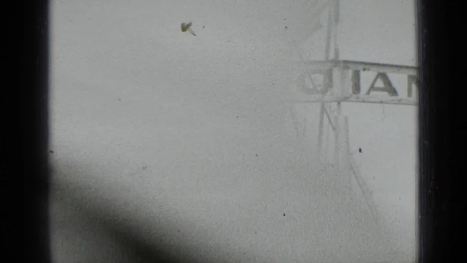 A washed-out fairground view shows part of a large structure with GIANT visible, likely connected to the ride setting described in metadata.