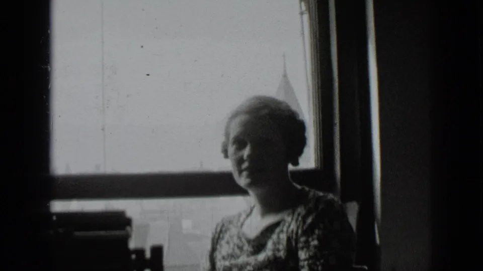 The woman appears partly silhouetted near the bright window, continuing the intimate 1939 New York interior view.