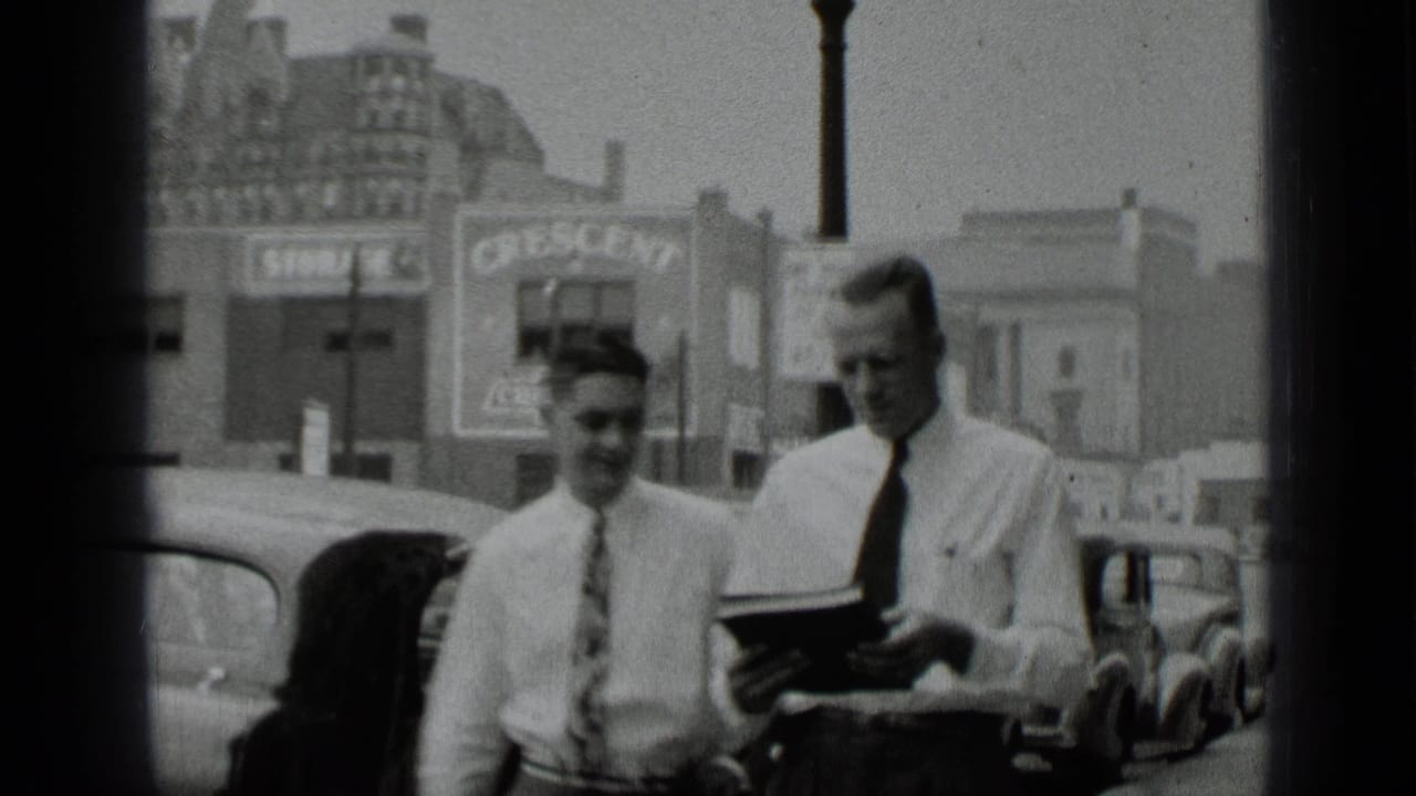 Men in ties pass in front of parked cars, with Crescent Chevrolet signage visible in the 1939 New York street scene.