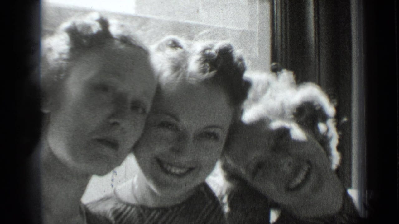 Three women pose shoulder to shoulder near a window, with one leaning her head sideways.