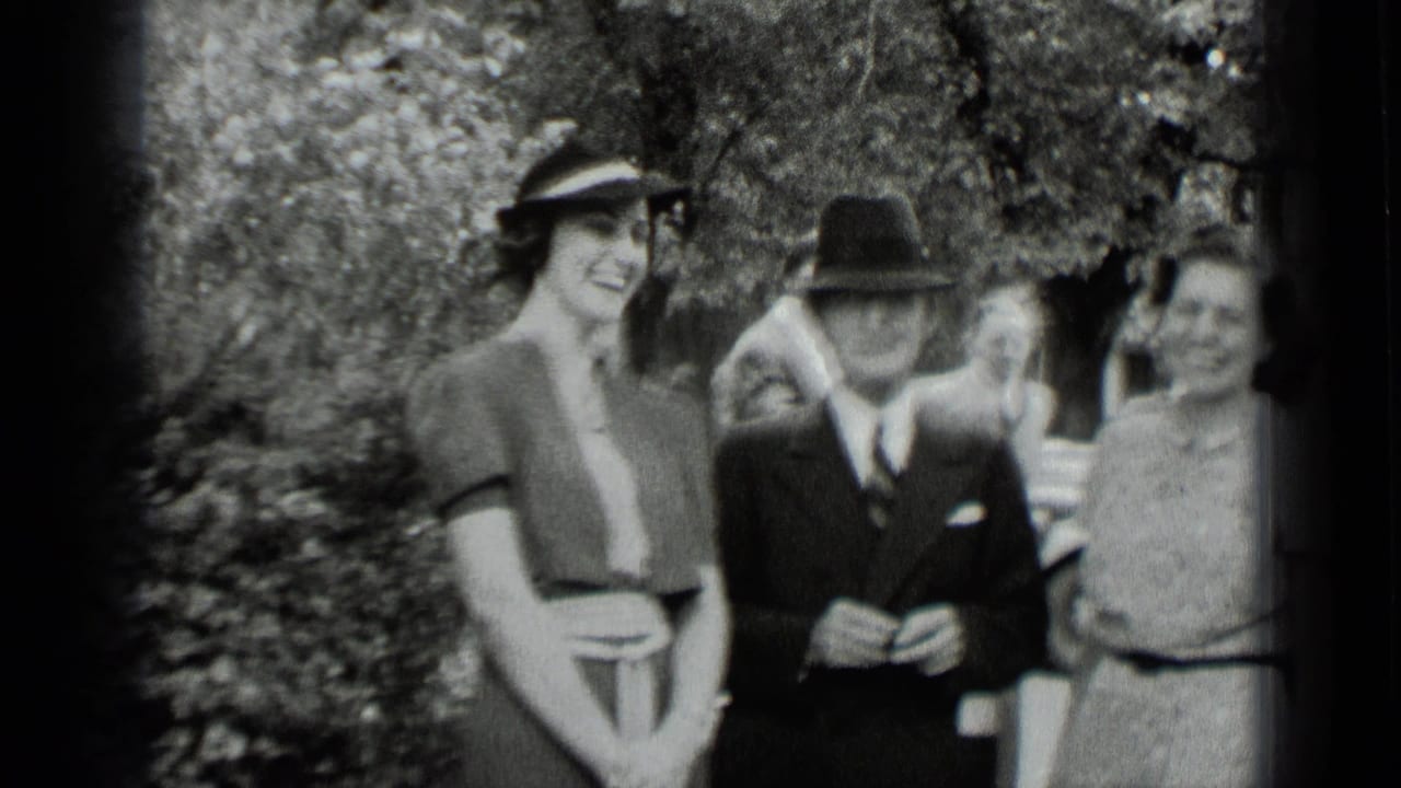 Women and a man in period clothing standing outdoors near trees.