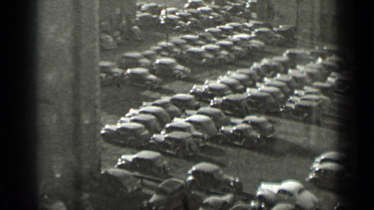 High-angle view of many parked cars in a dense urban lot.