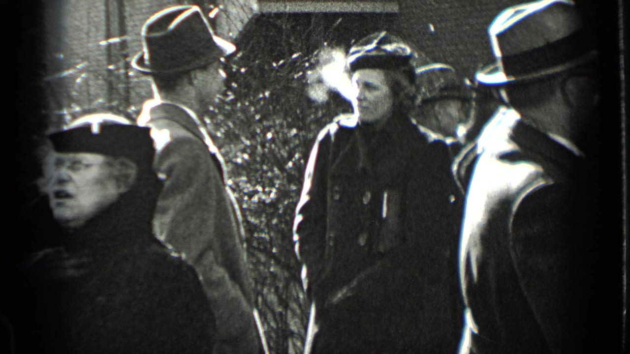 In 1939 New York, bundled adults in coats and hats socialize on a sidewalk as cold breath is visible in the winter air.