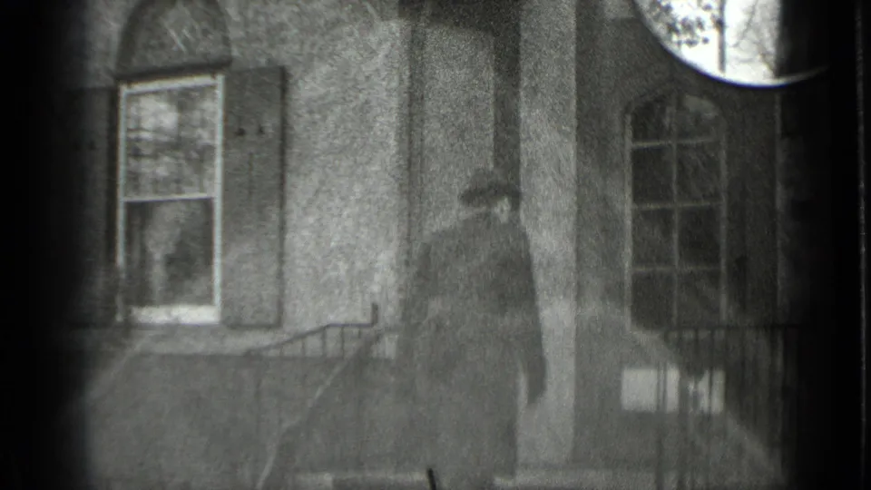 Black-and-white 1939 New York frame showing a man ascending steps toward a house entrance with shuttered windows.