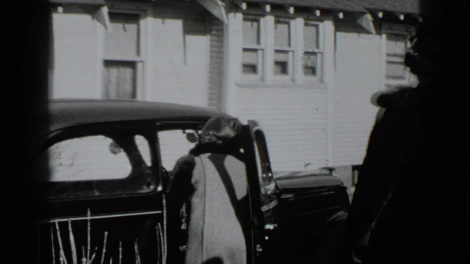 The final frame shows an adult by a vintage car door, with a second figure partly visible at the edge of a residential scene.