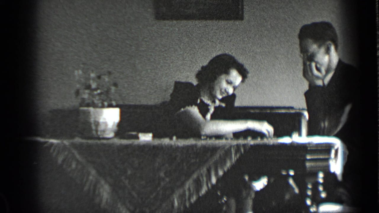 Woman leans toward the checkers board while the man watches beside her.