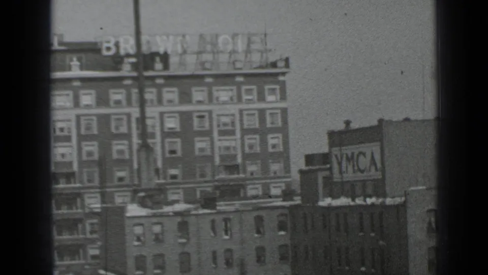 1939 New York frame with the Brown Hotel sign on a multi-story building and a YMCA sign on a neighboring structure after the camera pan.