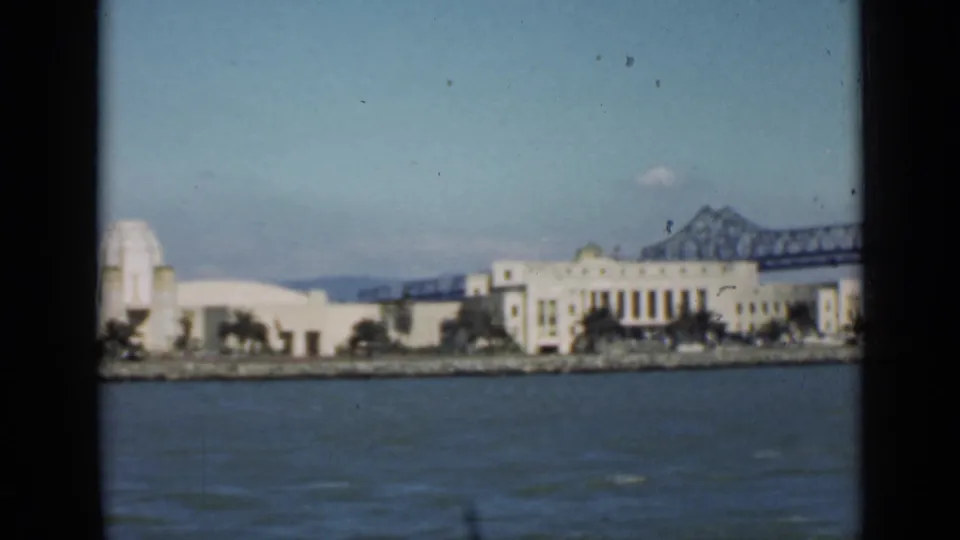 San Francisco bay view with white waterfront architecture and the bridge receding behind the buildings.