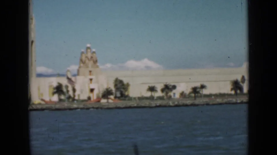San Francisco waterfront architecture and palms appear across the bay in this soft 1939 home-movie frame.